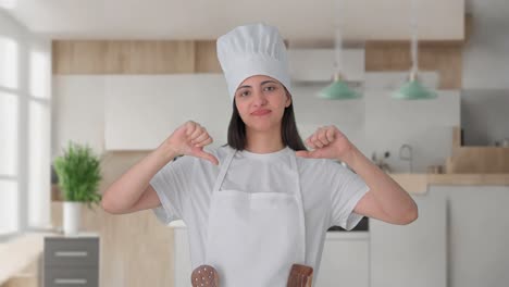 Upset-Indian-female-professional-chef-thumbs-down