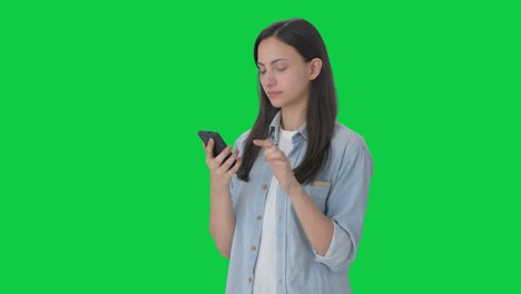 Serious-Indian-girl-using-phone-Green-screen