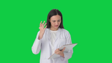 Confused-Indian-female-scientist-taking-notes-Green-screen