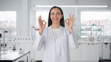Happy-Indian-female-scientist-showing-okay-sign