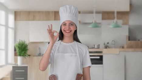 Happy-Indian-female-professional-chef-showing-okay-sign