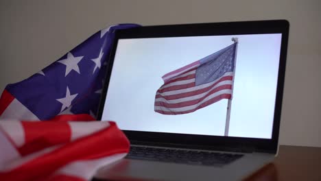 Open-laptop-and-flag-of-the-USA-on-the-screen-composing.