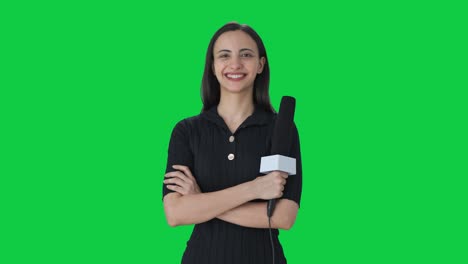 Portrait-of-happy-Indian-female-news-reporter-Green-screen