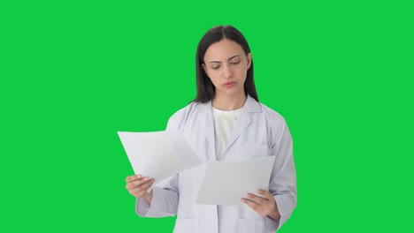 Indian-female-scientist-reading-reports-Green-screen
