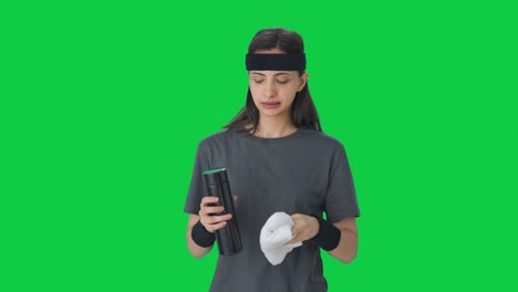 Indian-girl-wiping-sweat-and-drinking-water-after-workout-Green-screen