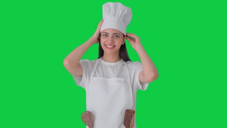 Happy-Indian-female-professional-chef-getting-ready-for-cooking-Green-screen