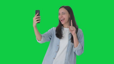 Happy-Indian-girl-clicking-selfies-Green-screen