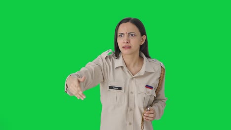Angry-Indian-female-police-officer-using-whistle-to-call-someone-Green-screen