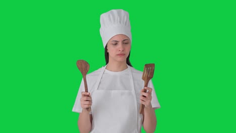 Indian-female-professional-chef-posing-with-spoon-and-spatula-Green-screen