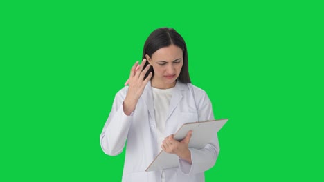 Stressed-Indian-female-scientist-taking-notes-Green-screen