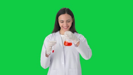Happy-Indian-female-scientist-doing-experiments-in-a-lab-Green-screen