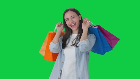 Happy-Indian-girl-doing-a-lot-of-shopping-Green-screen