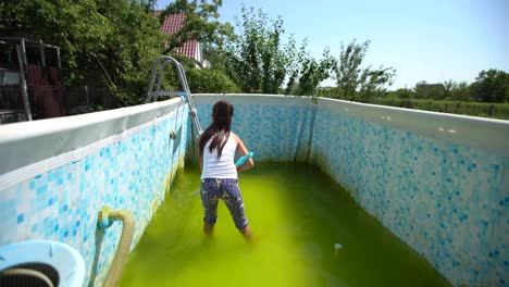 a-little-girl-cleans-a-very-dirty-pool