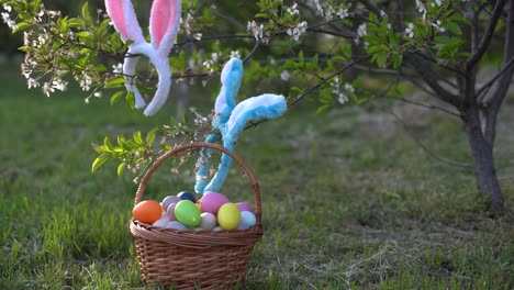painted-Easter-eggs-in-basket-on-grass.-Traditional-decoration-in-sun-light