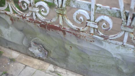 Handyman-scrape-the-old-paint-from-rusty-fence