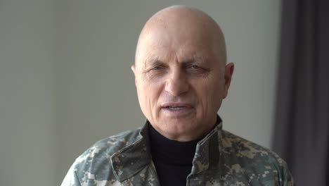 Headshot-of-aged-Caucasian-military-man-indoors.-Close-up-portrait-of-frustrated-depressed-veteran-in-uniform.-Mental-health-problems-and-crisis-concept