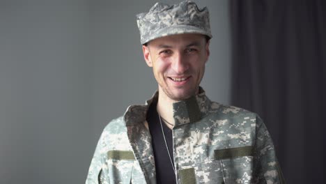 Portrait-of-a-man-in-military-fatigues,-face-to-camera