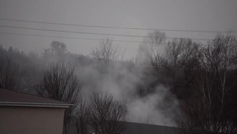 fire-in-a-private-house-thick-smoke-rises-above-the-roofs.