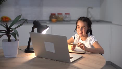 Kids-distance-learning.-Cute-little-girl-using-laptop-at-home.-Education,-online-study,-home-studying,-technology,-science,-future,-distance-learning,-homework,-schoolgirl-children-lifestyle-concept.