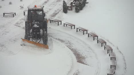 Tractor-vehicle-cleaning-the-yard-from-the-snow-storm