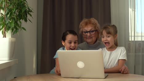 Grandmother-with-granddaughter-use-laptop-learn-counting-together-home