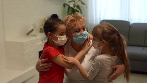 an-adult-woman,-a-retired-grandmother-with-a-granddaughters-wearing-a-medical-mask-in-home-quarantine,-because-of-COVID-19