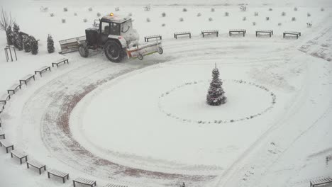 Tractor-vehicle-cleaning-the-yard-from-the-snow-storm