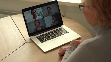 Video-call.-Good-looking-elderly-lady-i-having-a-video-call-on-laptop