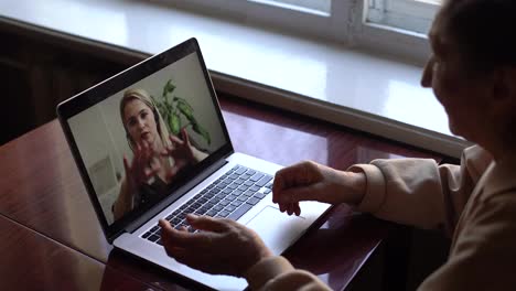 Senior-woman-make-video-call-using-laptop-at-home.-COVID-19-Stay-connected.-Online-chatting-with-assistants