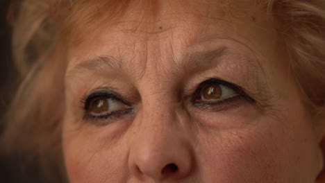 Macro-shot-of-senior-woman-face.-Cropped-portrait-of-elderly-woman-face-with-wrinkles-around-brown-eyes.-Close-Up-On-Eyes-Of-Serious-Mature-Woman