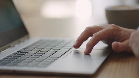 Close-up-hand-of-man-scrolling-a-Website-Using-Laptop-Track-Pad.-Computer-keyboard.-Using-Touchpad-Of-Laptop.-The-man-is-finger-scrolls-presses-and-zooms-on-the-laptop-touchpad-close-up