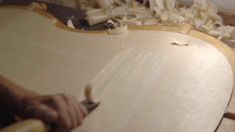 Anonymous-luthier-creating-violin-in-workshop