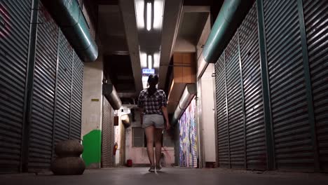 Young-ethnic-woman-walking-in-underground-corridor