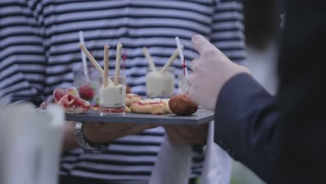 Wedding-guest-taking-cone-canape-from-waiter
