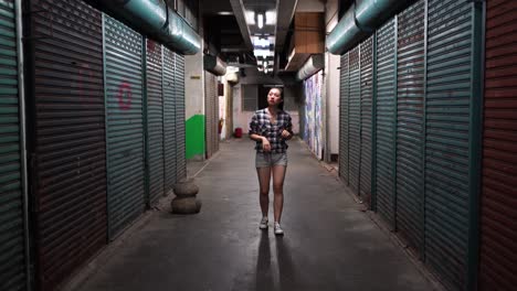 Woman-with-headset-walking-in-underground-corridor