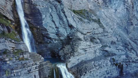 Rapid-waterfall-flowing-through-rocky-cliff-slope