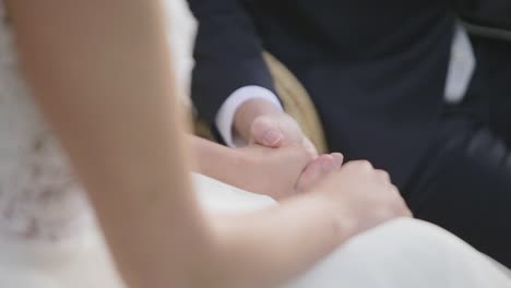 Man-and-woman-on-wedding-garments-and-holding-hands