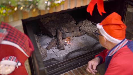 Man-lighting-fireplace-on-Christmas-day