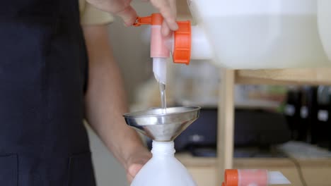 Person-pouring-soap-from-dispenser