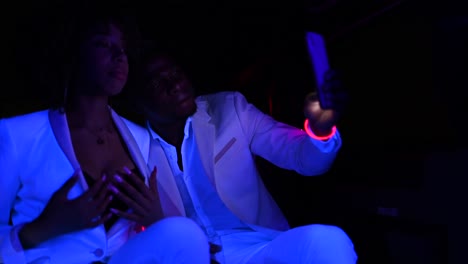 African-American-couple-taking-selfie-in-limousine