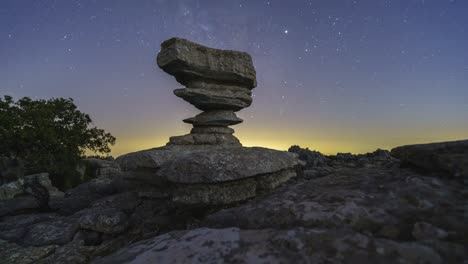 Tree-and-rock-formation-against-night-sky