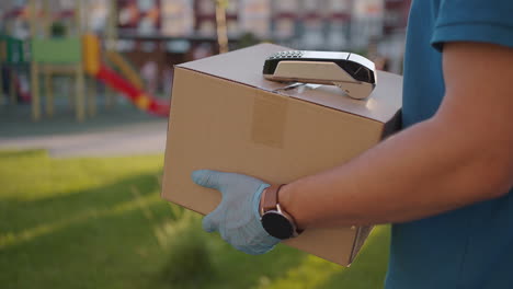 postman-or-delivery-man-carry-small-box-deliver-to-customer-at-home-contactless-nfc-terminal-payment.