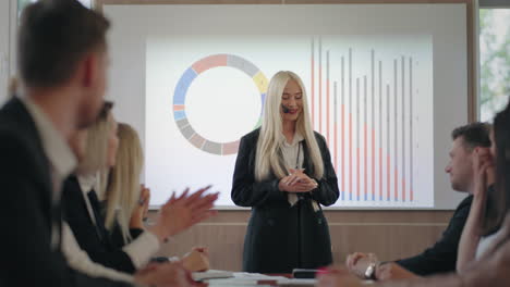 attractive-blonde-woman-is-speaking-in-business-conference-in-field-of-finance-and-accounting