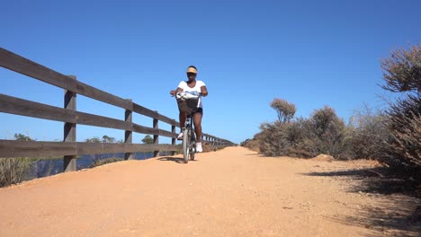 Black-woman-riding-a-bike-on-a-terrain-path
