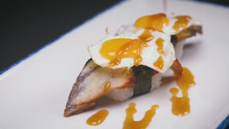 Sauce-spilling-on-sushi-with-fried-eggs