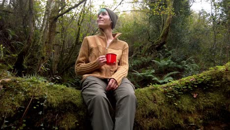 Traveling-woman-with-cup-of-coffee-in-woods