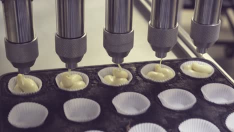 Anonymous-baker-on-muffin-preparation-with-automatic-machine