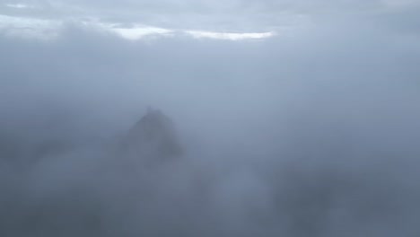 Ruins-on-mountain-peak-above-clouds-on-foggy-day