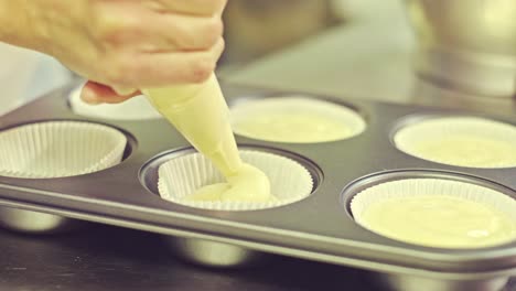 Chef-preparing-muffins-in-kitchen
