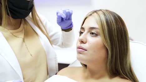 Crop-anonymous-beautician-injecting-botox-in-female-face